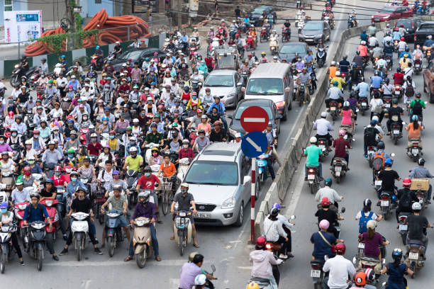 Hanoi, Vietnam - Sep 14, 2016: Aerial view of traffic in rush hour in Truong Chinh street Hanoi, Vietnam - Sep 14, 2016: Aerial view of traffic in rush hour in Truong Chinh street vietnamese man taxi motorbike driver stock pictures, royalty-free photos & images