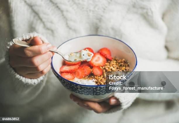 Healthy Breakfast Yogurt Granola Strawberry Bowl In Womans Hands Stock Photo - Download Image Now