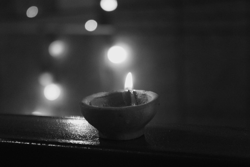 Single oil lamp lighting at the time of Diwali Festival of Hindus, India.