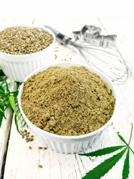 istock Flour hemp and grain in bowls with leaf on board 646868150