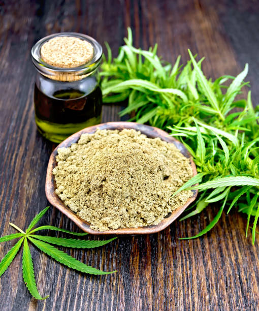 istock Flour hemp in bowl with oil and leaf on board 646868290