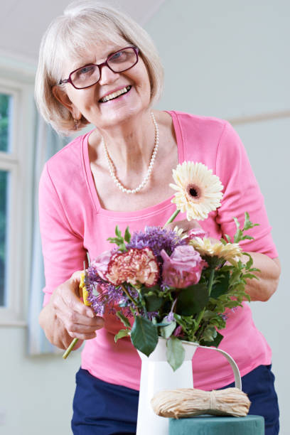 istock Senior Woman In Flower Arranging Class 646868296
