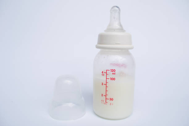 istock Baby bottle with milk and a measuring scale 646869150