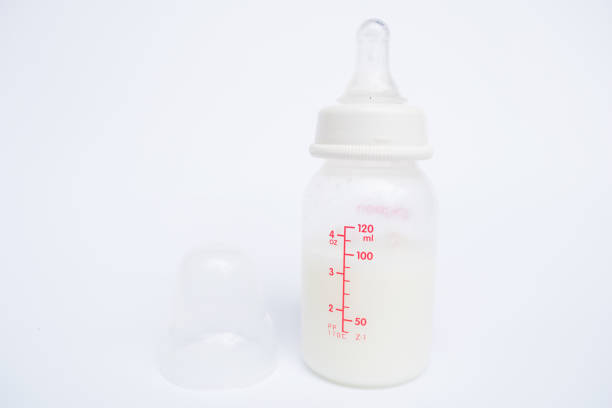 istock Baby bottle with milk and a measuring scale 646872434