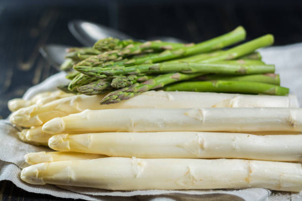 istock Spring season - fresh white and green uncooked asparagus 646872714