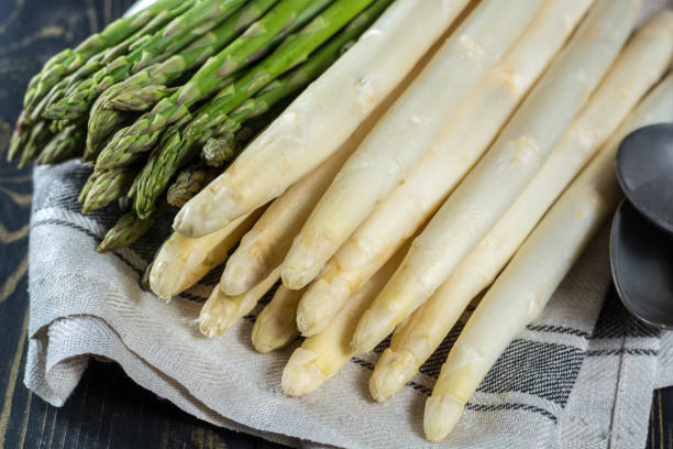 istock Spring season - fresh white and green uncooked asparagus 646872740
