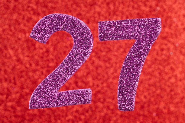 istock Number twenty-seven purple color over a red background. Anniversary. 646879904