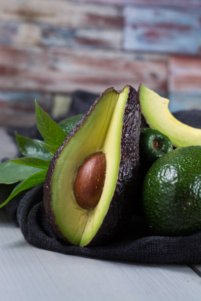 istock Green ripe avocado with leaves 646880668