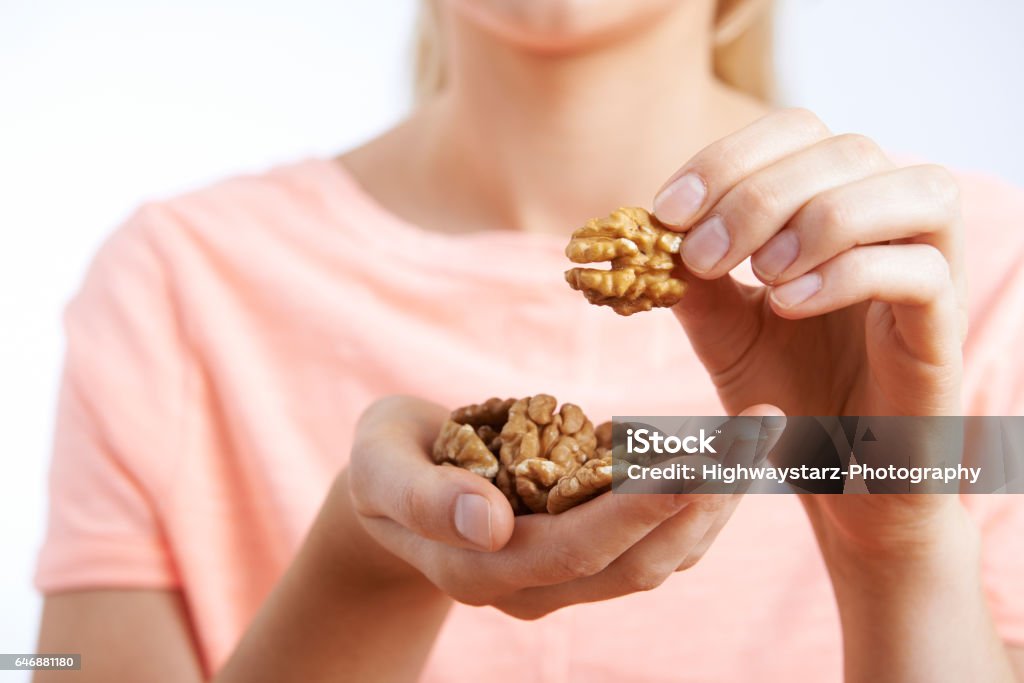 Close Up Of Woman Eating Walnuts Walnut Stock Photo