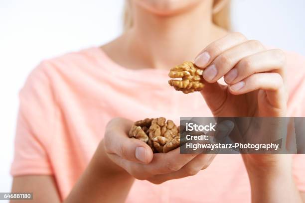 Close Up Of Woman Eating Walnuts Stock Photo - Download Image Now - Walnut, Eating, Nut - Food