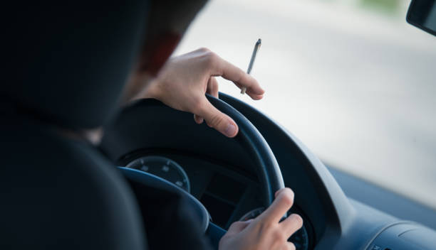 Man driving and smoking joint Man driving and smoking joint hashish photos stock pictures, royalty-free photos & images