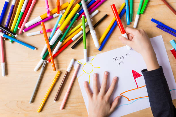 istock Hands of a child taking red marker 646884470