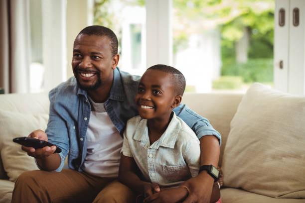 istock Son and father watching television 646888750