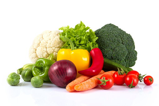 Close-up, bright fresh vegetables, fruits and berries on a green background, flat lay.