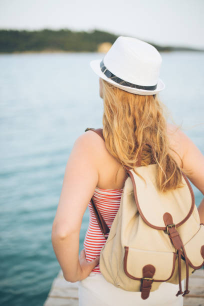 istock Young woman relaxes on pier 646899828