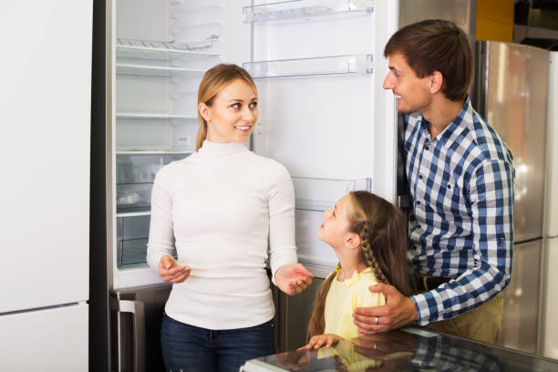 istock Family choosing refrigerator in store 646899886