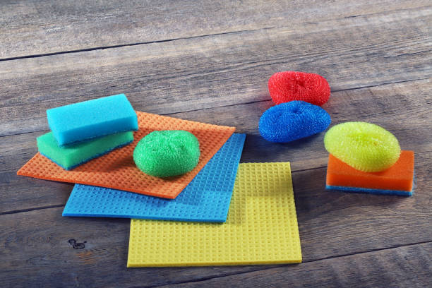 istock Sponges, rags, brush for cleaning on a wooden table 646908610