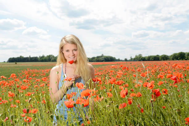 istock woman in poppy field 646915150