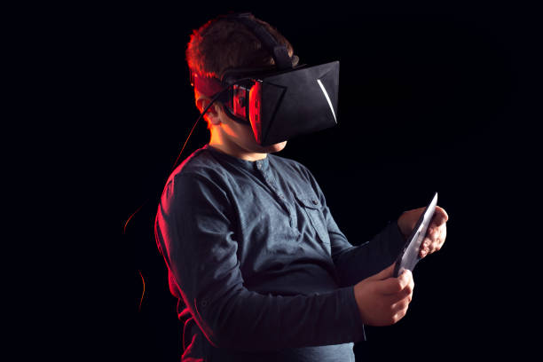 istock Joyful kid looking in a VR goggles 646919634