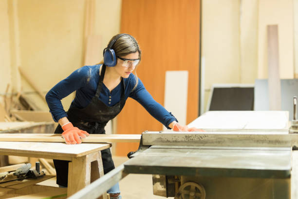 istock Woman using table saw in a woodshop 646920550