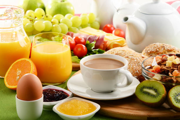 istock Breakfast served with coffee, orange juice, egg and fruits 646926574