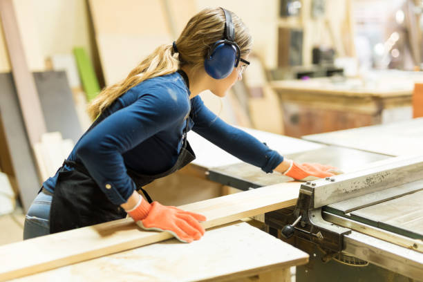 istock Woman cutting some wood with a table saw 646927414