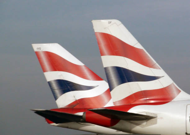 Tail Of British Airway Passenger Airplane Parked At Heathrow Airport London.England.Europe View Of Tail Of British Airway Passenger Airplane Parked At Heathrow Airport London England Europe british airways stock pictures, royalty-free photos & images