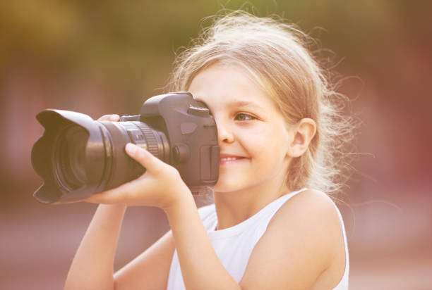 istock girl  holding photo camera 646930256