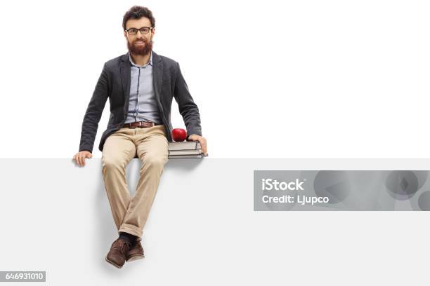 Young Teacher Sitting On Panel And Looking At The Camera Stock Photo - Download Image Now