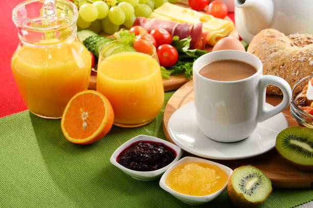 istock Breakfast served with coffee, orange juice, egg and fruits 646937892