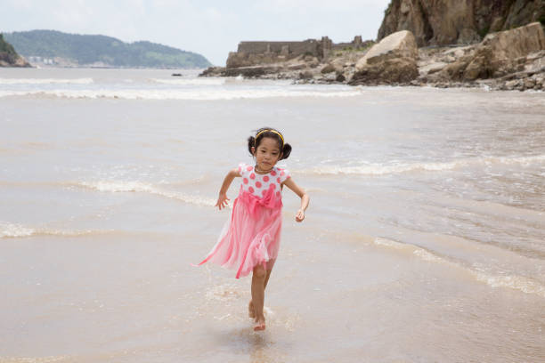 istock Girl running on the beach. 646945572