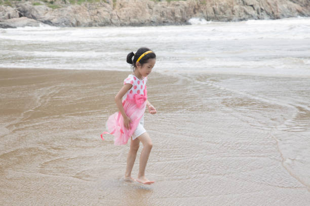 istock The girl walking on the beach 646945624