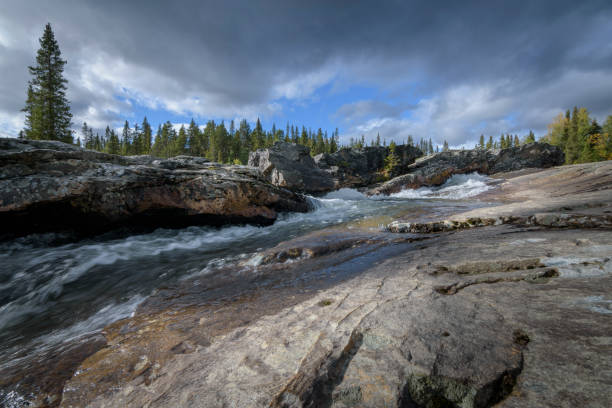 istock Beautiful rocky waterfall in sweden in magic pine forest landscape 646945636