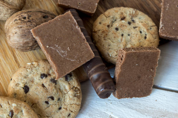istock Cookies, walnut and chocolate on white wooden background 646946222