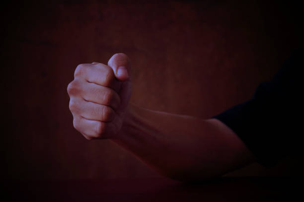 istock Male fist on grey background 646950268