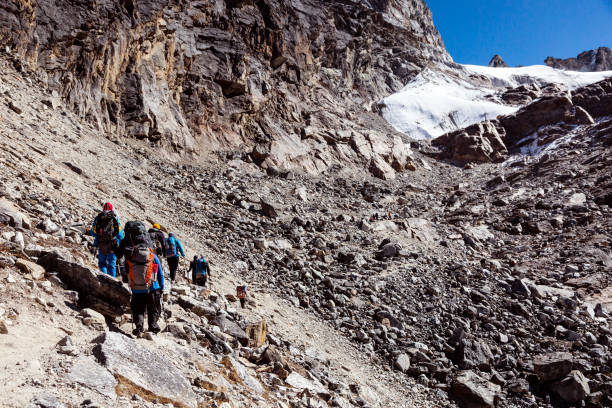 istock Group of Mountain Climbers walking on rocky slope toward Pass 646950682