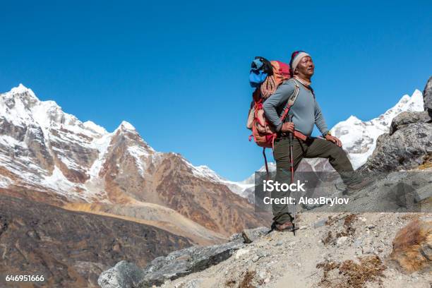 High Altitude Himalaya Nepalese Guide Looking Up Stock Photo - Download Image Now - Sherpa, Guide - Occupation, Nepal