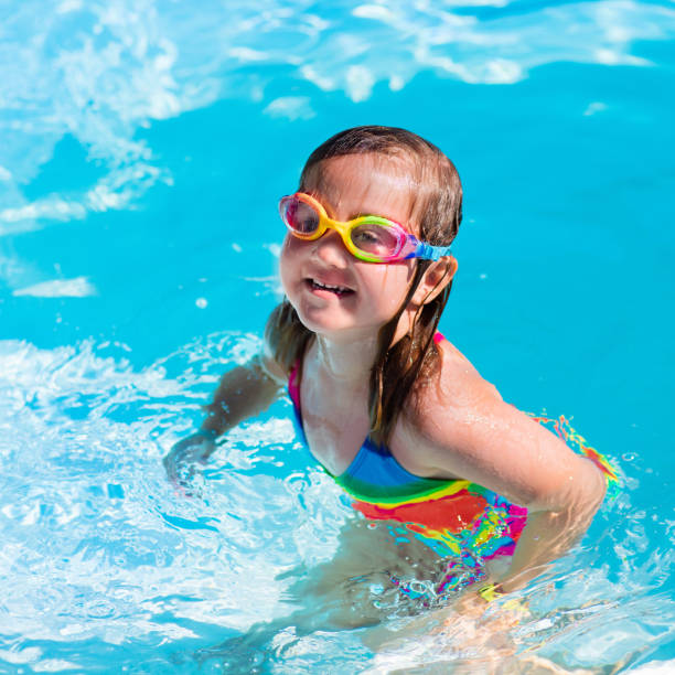 istock Child learning to swim in pool 646957654