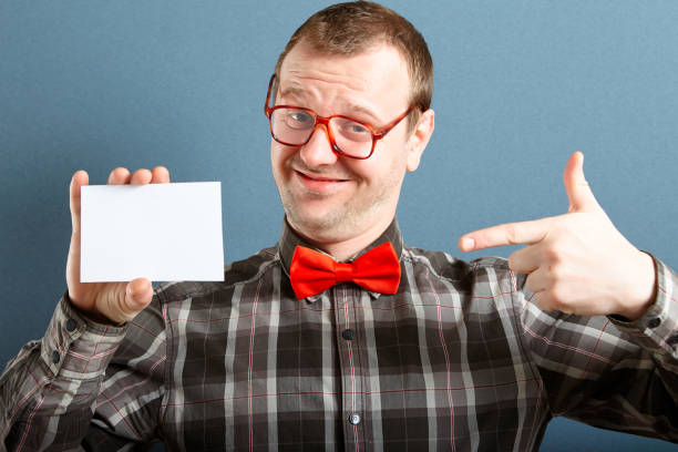 nerd guy with blank card - glasses holding business card imagens e fotografias de stock