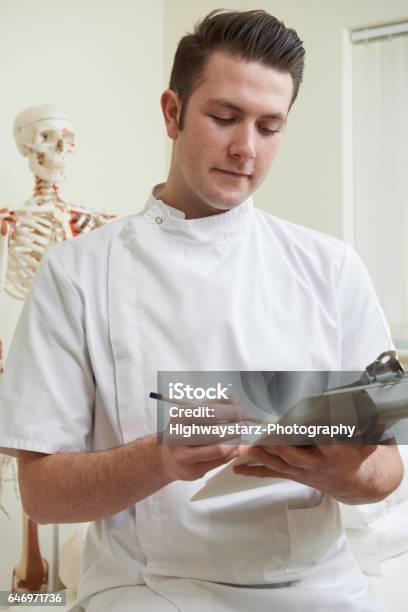 Portrait Of Osteopath In Consulting Room Stock Photo - Download Image Now - 20-29 Years, Adult, Adults Only