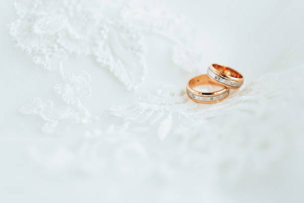 istock Golden wedding rings on veil. Close-up 646974736