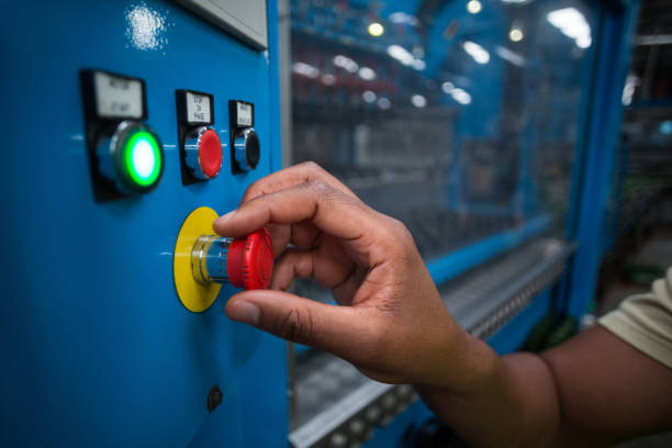 istock Hands of factory worker turning the control knob on the board 646980736