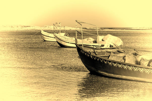 Small motor boats at the beach.  Fishing Boats moored in the mediterranean sea in Israel. Vintage Style Toned Picture