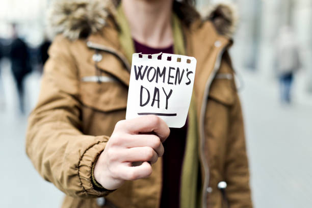 istock woman with a note with the text womens day 646982638