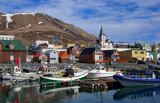 Boats for fishing and for whale watching tours gather at the port of Husavik, Iceland.