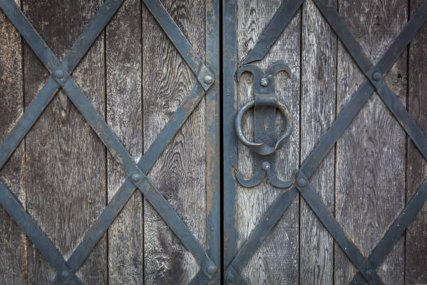 istock An old wooden gate is decorated by the forged grate 647000008