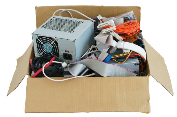 Cardboard box with the old used computer stuff  waste and garbage. Isolated with patch Cardboard box with the old used computer stuff  waste and garbage. Isolated with patch. All logos and bradns removed recycling computer electrical equipment obsolete stock pictures, royalty-free photos & images