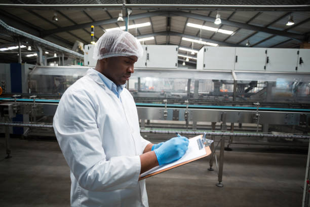 istock Factory engineer maintaining record on clipboard in factory 647004232