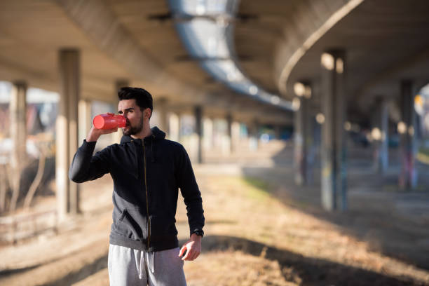 istock Man Runner Under Bridge in the City Taking Brake 647007350