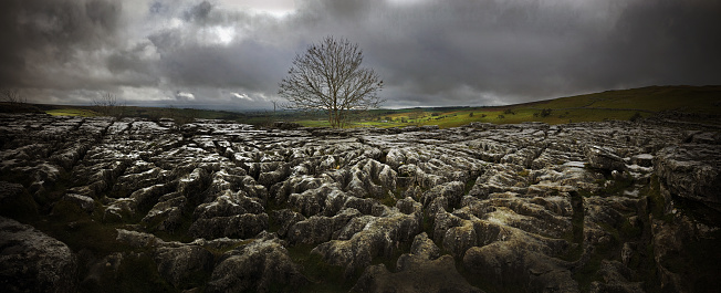 Dramatic story light at Malham Cove limestone pavement in the North Yorkshire Dales, England, UK